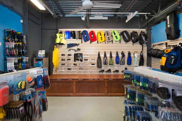 dive shop back wall with fins masks and bladders for beds
