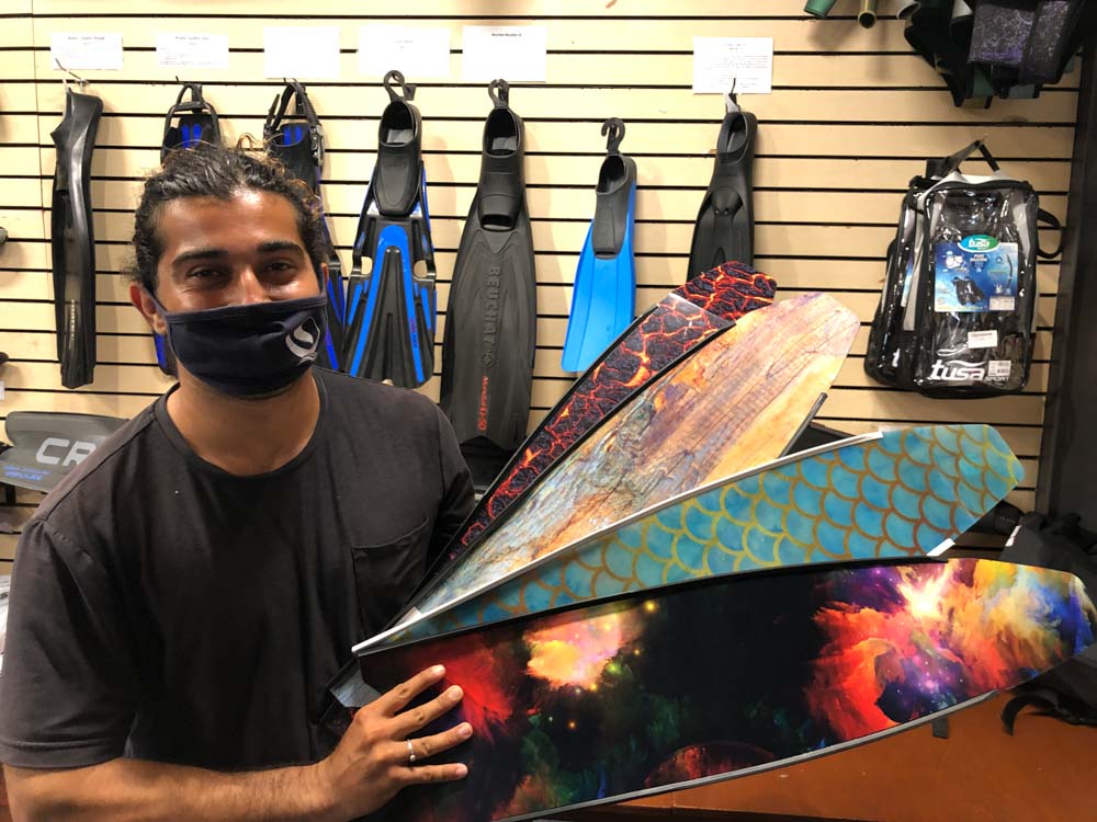 employee holding freediving fins
