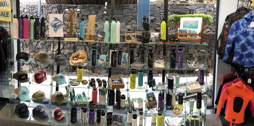 dive shop in Kona Hawaii glass display with fifty fifty flasks and other products