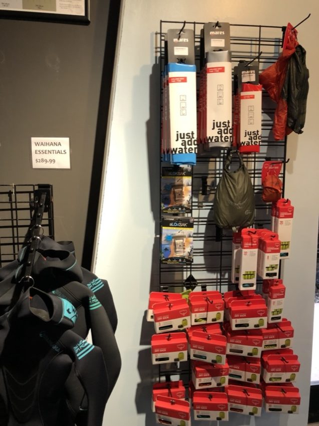 freediving wetsuits and dry bags on display