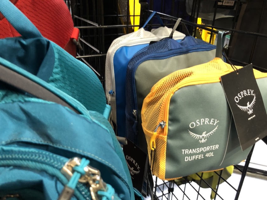 osprey bags on dive shop display grid wall