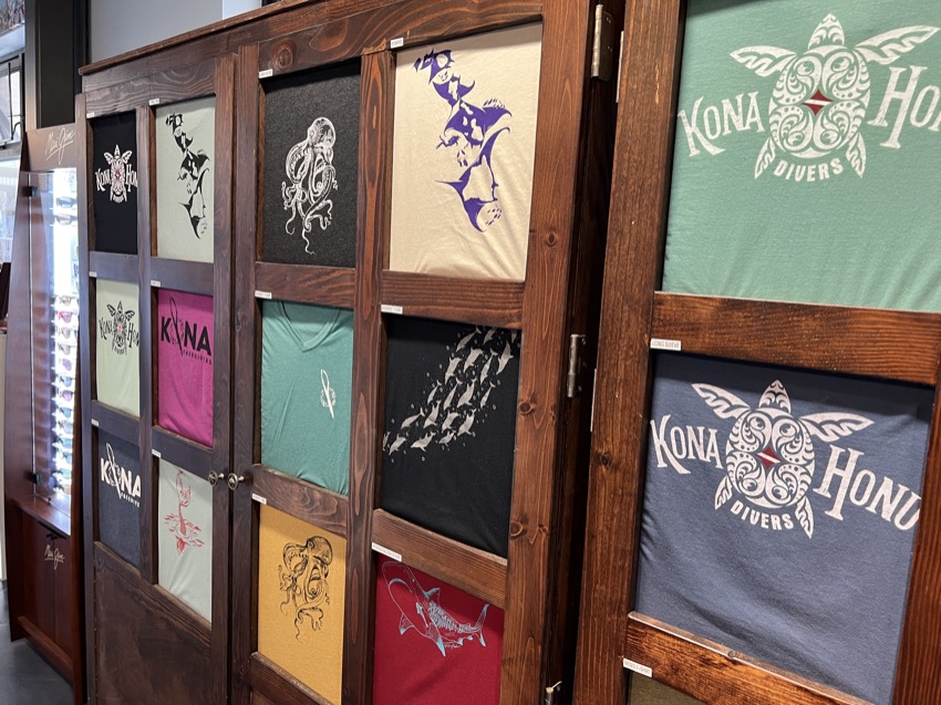 wooden cabinet with t shirt designs in windows