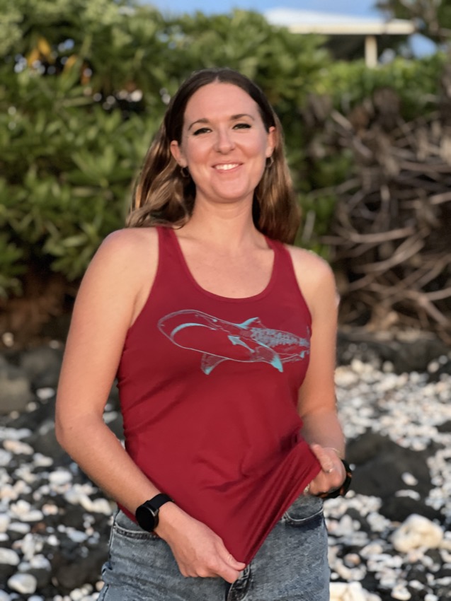 woman in a red tank top with Kona blue tigershark on front