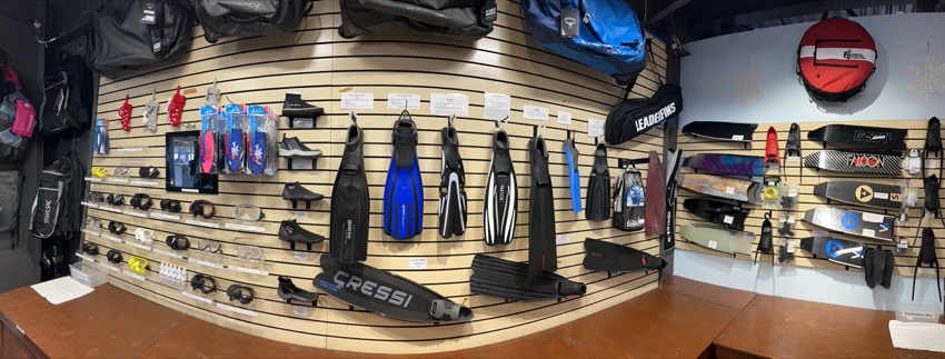 Wall of fins on display in dive shop