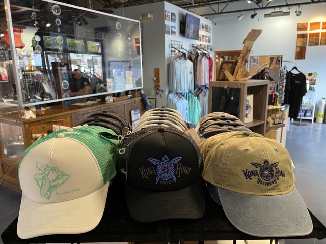 hats with Kona Honu Divers logo on display shelf