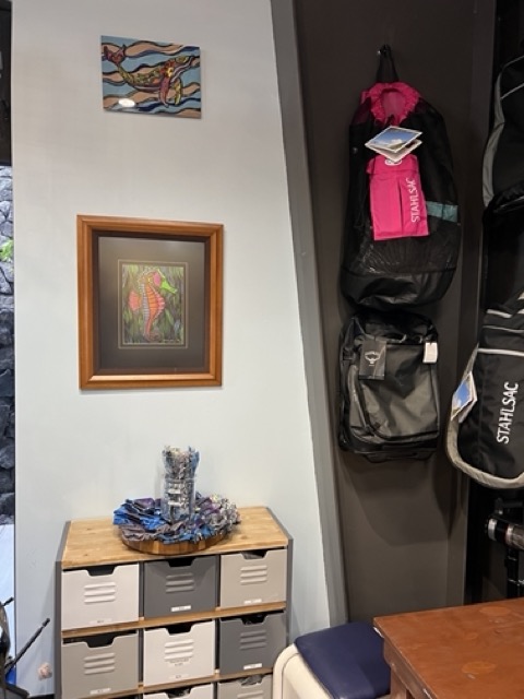inside of dive shop with with colorful picture of a seahorse on the wall