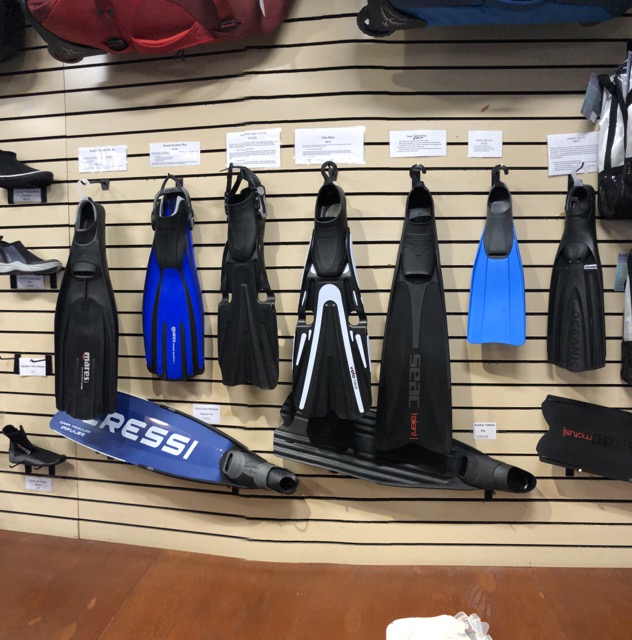 fins on wall in a dive shop