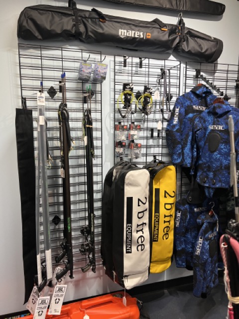 spearfishing and freediving gear in a dive shop