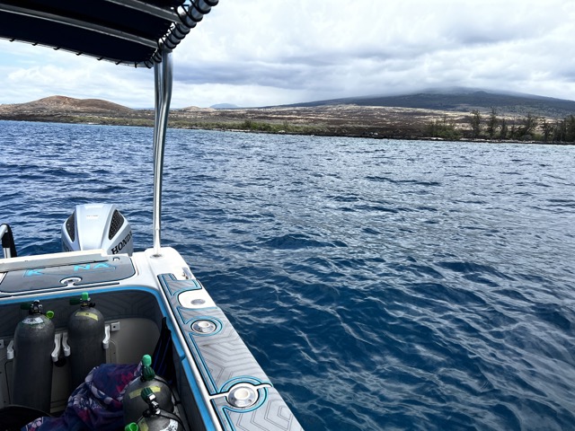 from inside a small boat looking out at the kona coast