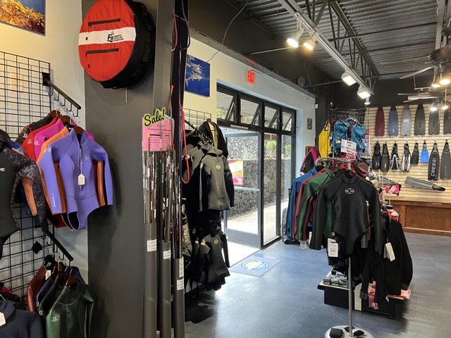 wetsuits and other products on display in a dive shop