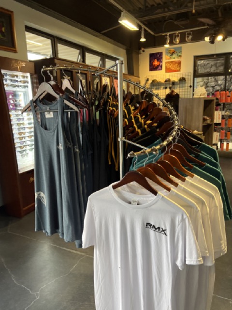 shirts on a rack inside a dive shop