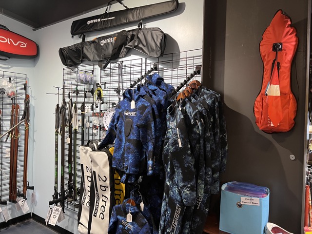 wetsuits and other spearfishing and freediving gear inside a dive shop