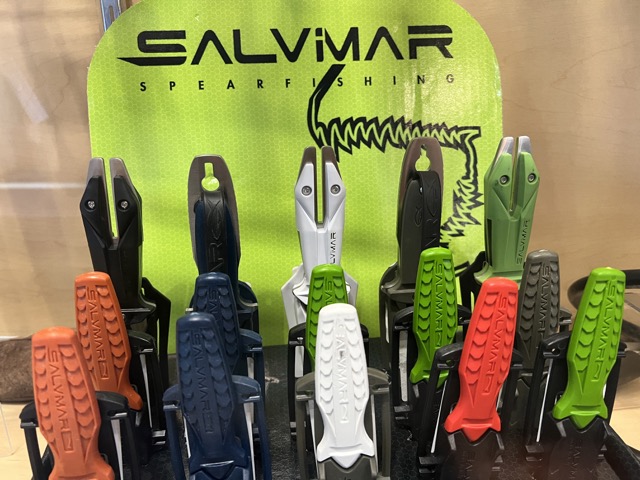 knives in a glass cabinet displayed inside a dive shop