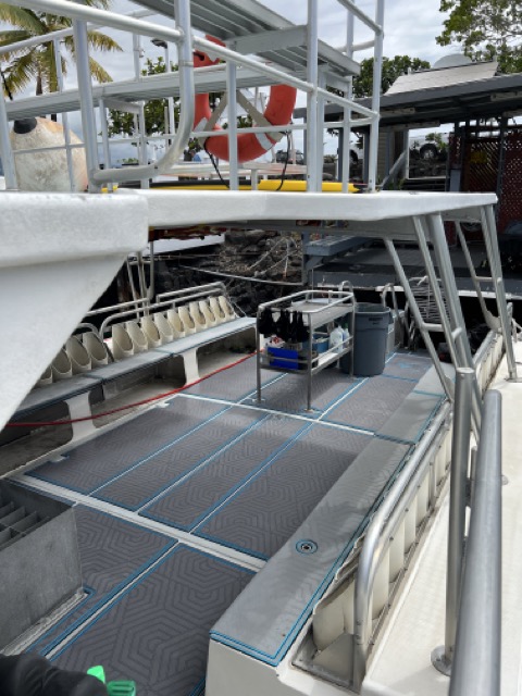 view from the side of a boat of the inside of the stern deck