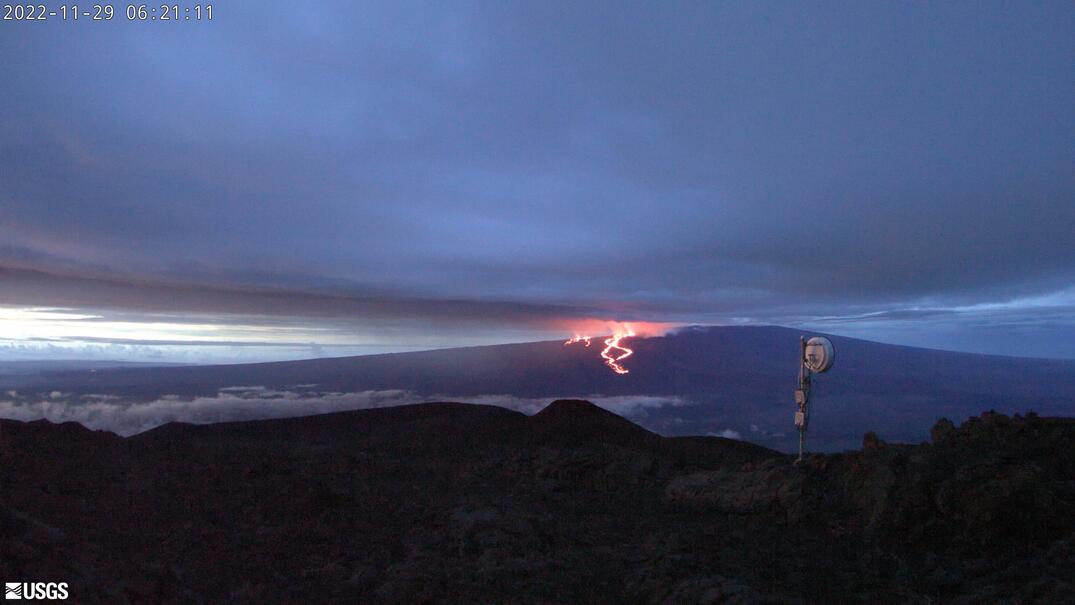 webcam image of a mountain with hot lava flowing down it