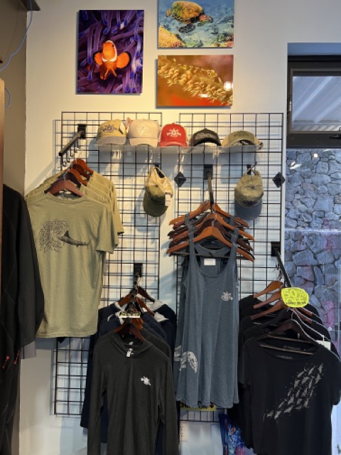 Inside a dive shop entry way with pictures and shirts on display