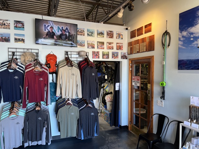 Inside a dive shop entry way with pictures and shirts on display 