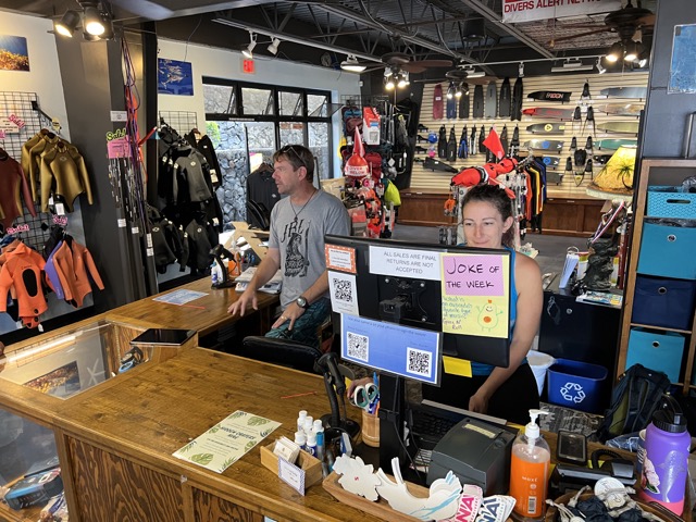 Inside a dive shop staff sit at front desk
