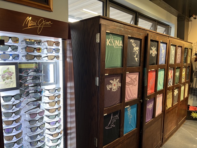 sunglasses and shirts on display inside a dive shop