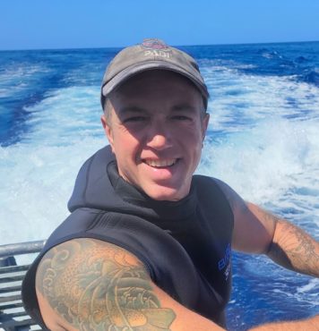 headshot of Matthew on a boat. he is a scuba instructor at Kona Honu Divers