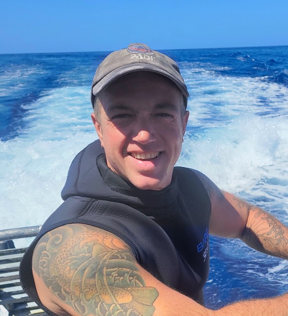 headshot of Matthew on a boat. he is a scuba instructor at Kona Honu Divers